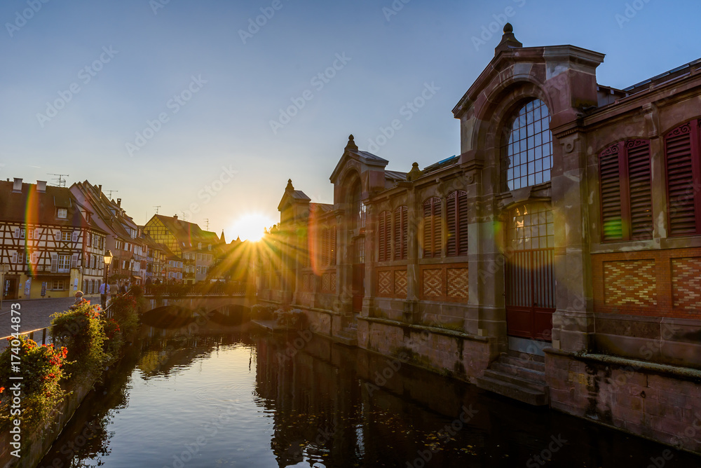 Beautiful view of the historic town of Colmar, also known as Little Venice, boat ride along traditional colorful houses on idyllic river Lauch in summer, Colmar, Alsace, France