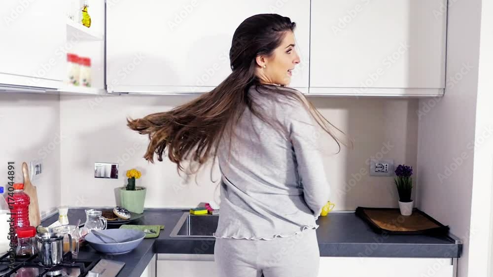 Gorgeous woman with long hair jumping happy in pajamas slow motion medium shot Gorgeous woman with long hair jumping happy in pajamas slow motion medium shot