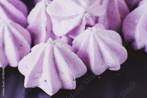 sweets and desserts, purple berry meringue or marshmallow with blueberries and blackberries on a dark background