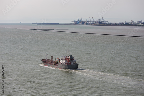 Cargo ship at river Seine near harbor of Le Havre, France photo