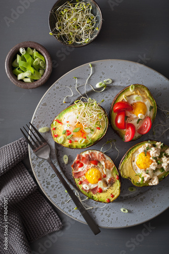 eggs baked in avocado with bacon, cheese, tomato and alfalfa sprouts