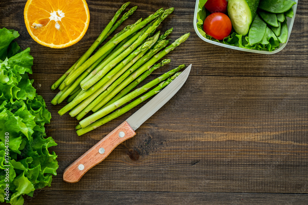 Healthy meal in containers. Salad with tomato and cucumber in cotainers on wooden background top view copyspace Healthy meal in containers. Salad with tomato and cucumber in cotainers on wooden background top view copyspace