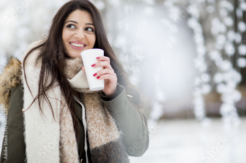 Pretty young woman drinking...