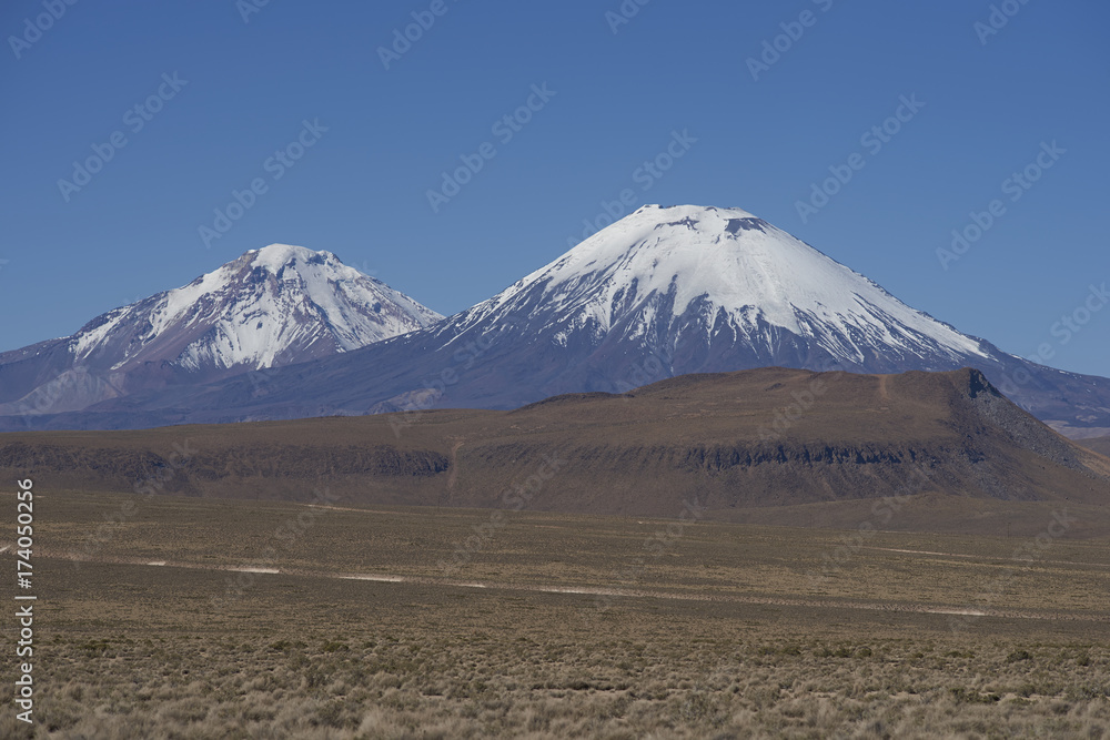 Volcanoes Parinacota and Pomerape in Lauca National Park high on the Altiplano of northern Chile.