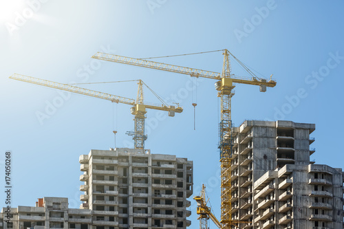 Houses under construction on the background of blue sky