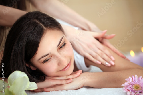 people, beauty, spa, healthy lifestyle and relaxation concept - close up of beautiful young woman lying with closed eyes in spa