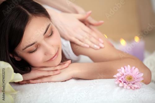 people  beauty  spa  healthy lifestyle and relaxation concept - close up of beautiful young woman lying with closed eyes and having face or head massage in spa