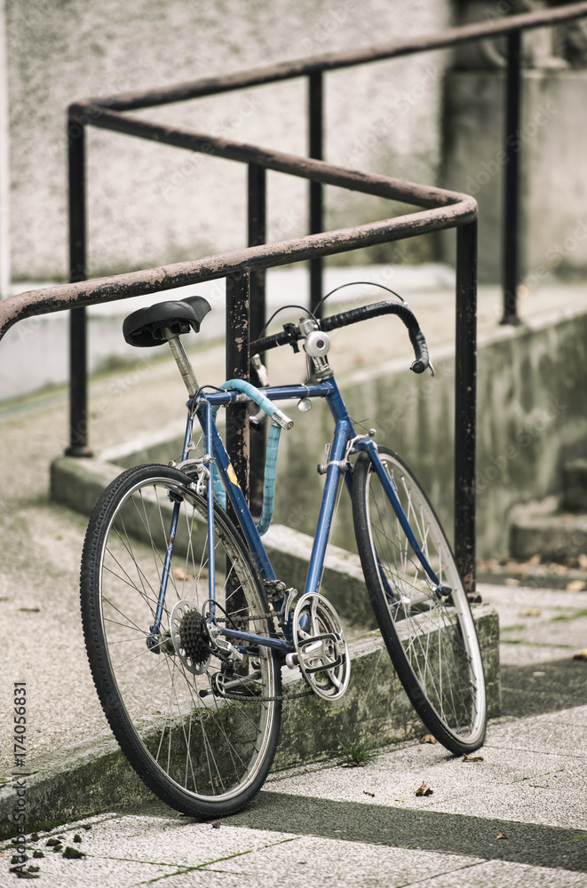 A beautiful city bike fastened to a metal fence. A beautiful city bike fastened to a metal fence.