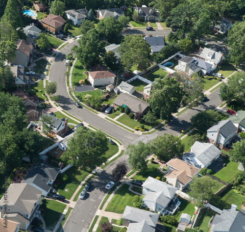 Aerial view of east coast suburban homes in quiet neighborhood house complex development outside New York City on bright summer day
