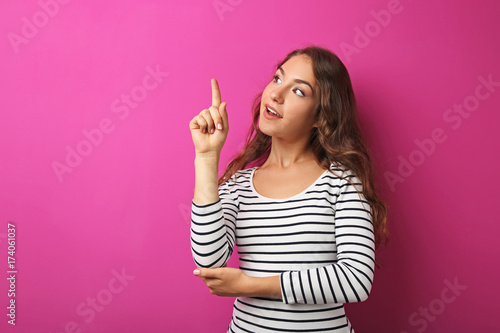 Portrait of young woman on pink background