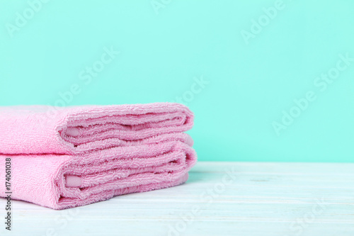 Pink towels on a green background