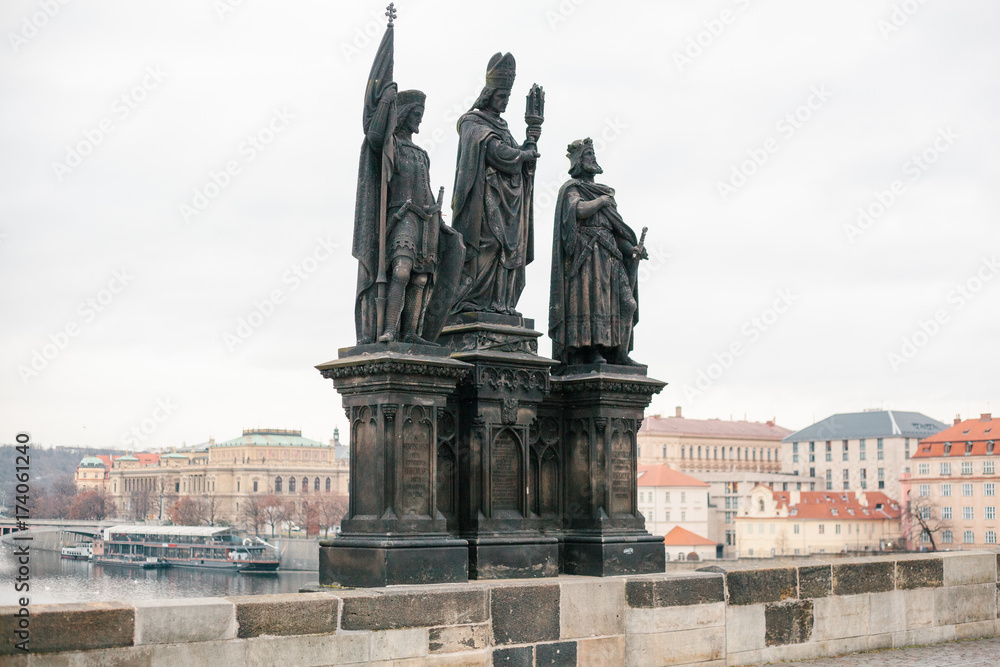 Sculptures of saints Norbert, Sigismund and Vaclav. One of the ancient statues on the Charles Bridge in Prague in the Czech Republic. European old architecture.
