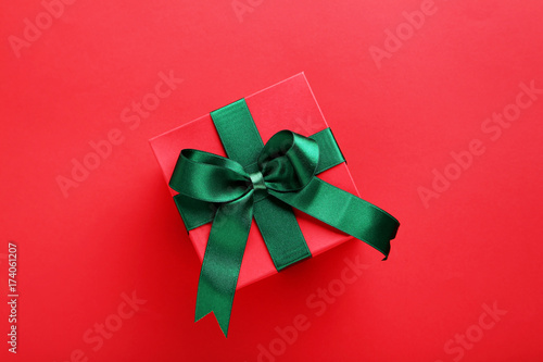 Gift box with ribbon on red background