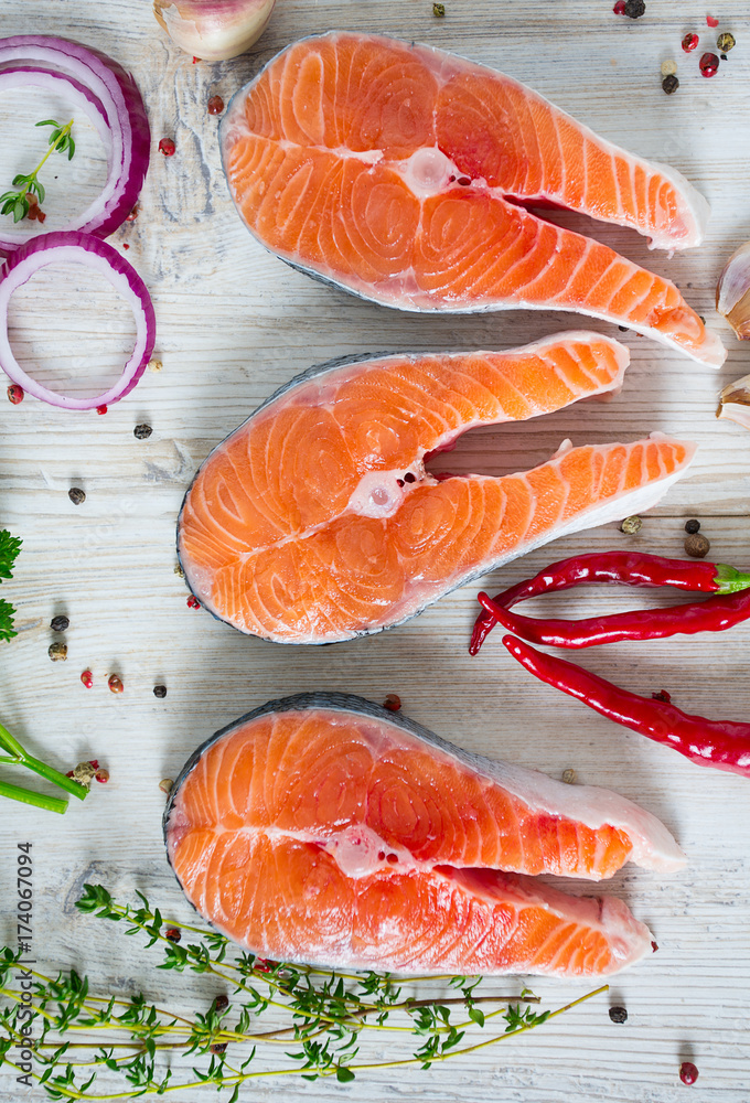 freshly cut raw salmon with spices on wooden surface freshly cut raw salmon with spices on wooden surface