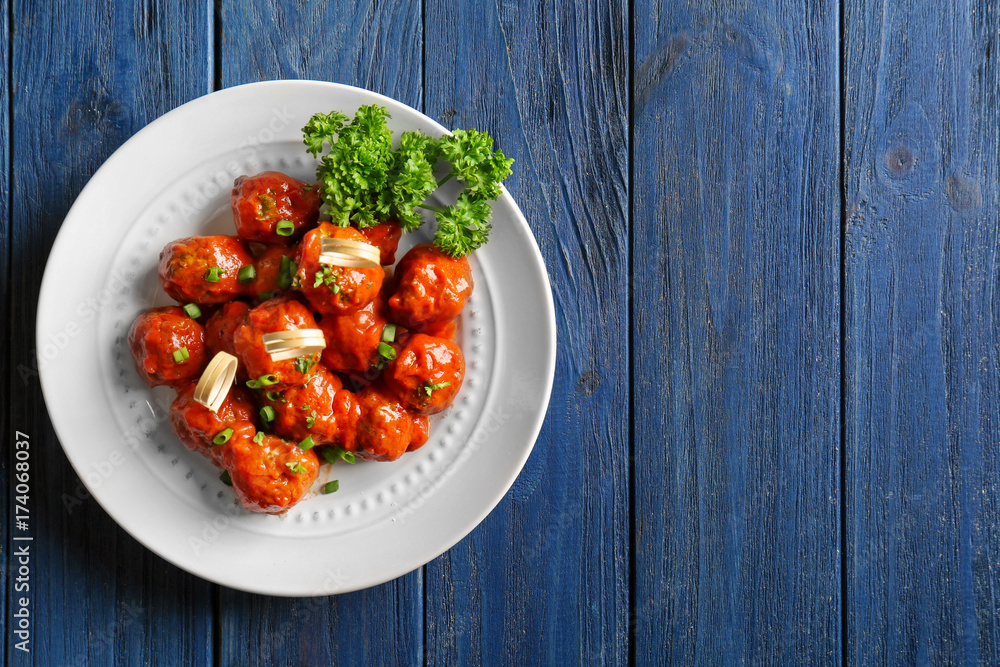 Plate with delicious meatballs on wooden table Plate with delicious meatballs on wooden table