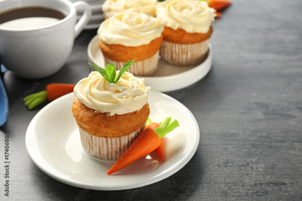 Plate with delicious carrot cupcake on table Plate with delicious carrot cupcake on table