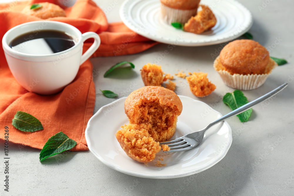 Plate with delicious carrot muffin on table