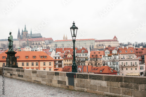 Charles Bridge in Prague in the Czech Republic. European old architecture. Lamppost and statue on the bridge.