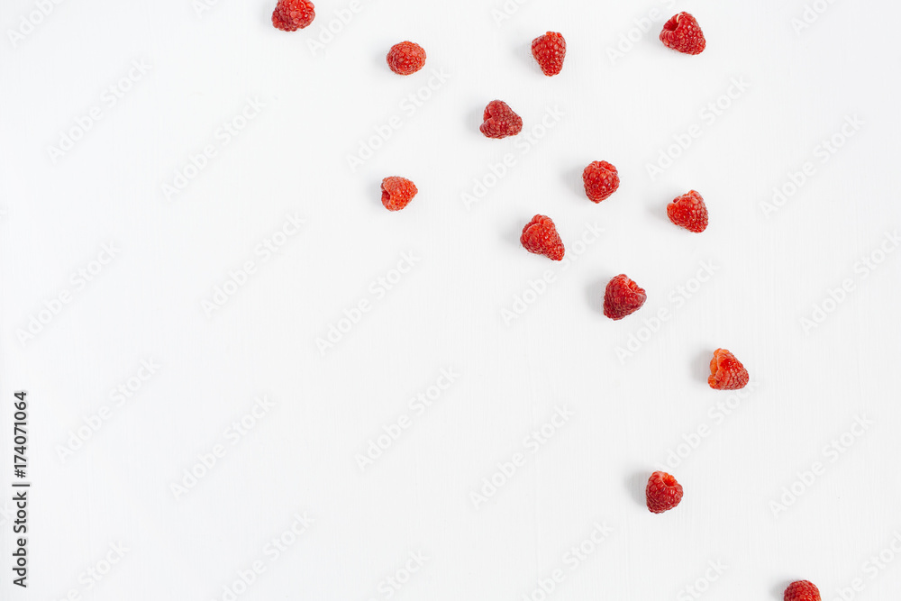 Raspberries on white background. Food blog or magazine concept texture.