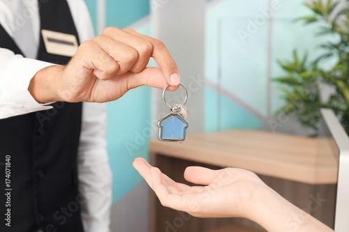 Wallpaper Mural Male receptionist giving room key to client in hotel Torontodigital.ca