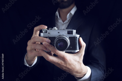 man hand camera on dark background