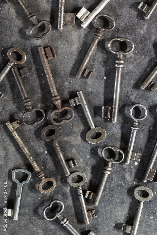 Many old keys on dark metal background Many old keys on dark metal background