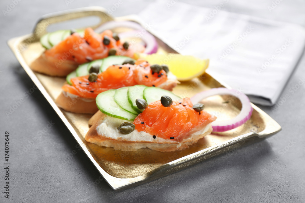 Delicious salmon bruschettas on metal tray Delicious salmon bruschettas on metal tray