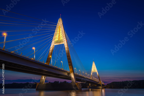Budapest, Hungary - The illuminated Megyeri Bridge over river Danube at blue hour with colorful clear sky