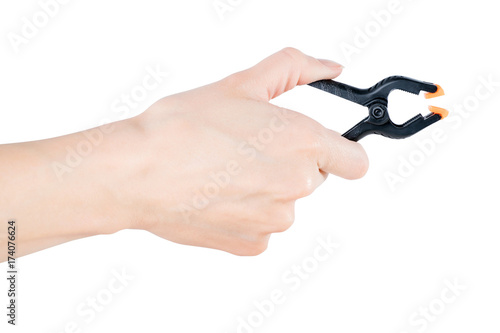 Woman hand holding black clamp, isolated with clipping path