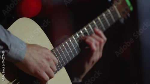 Close up guitarist playing live on stage at music event photo