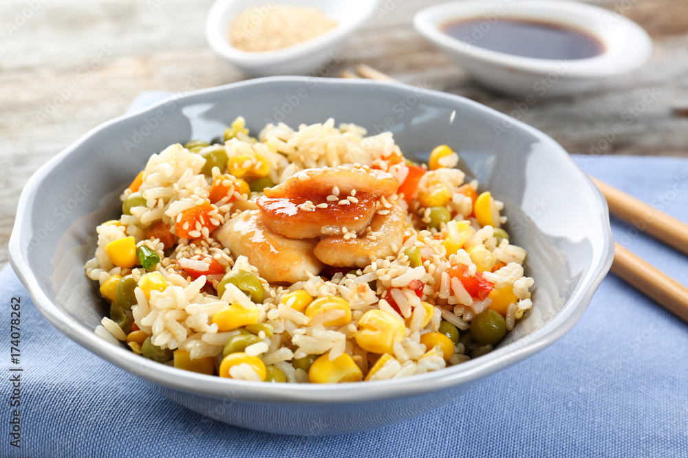 Bowl with brown rice and vegetables on table Bowl with brown rice and vegetables on table