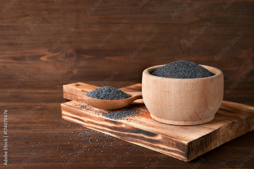 Ripe poppy seeds in kitchenware on wooden background Ripe poppy seeds in kitchenware on wooden background