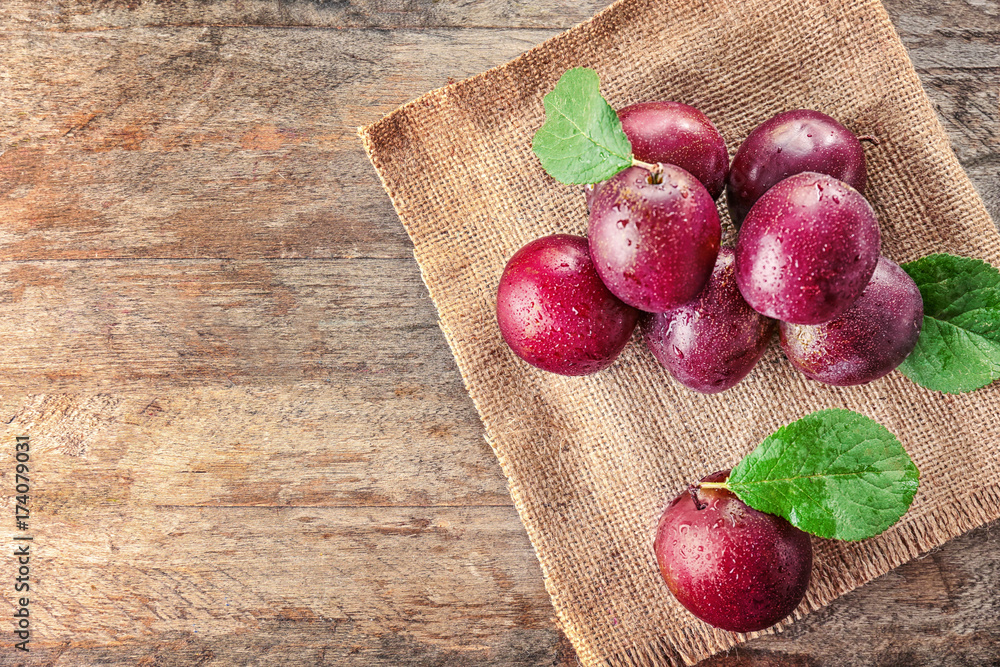 Fresh ripe plums on sackcloth Fresh ripe plums on sackcloth