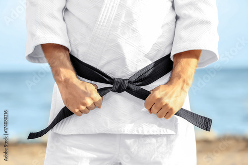 Male karate instructor outdoors, closeup