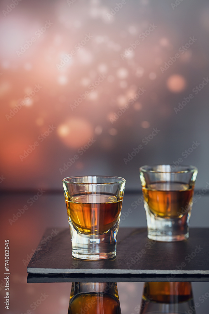 Cognac or liqueur, coffee beans and spices on a glass table. Cognac or liqueur, coffee beans and spices on a glass table.
