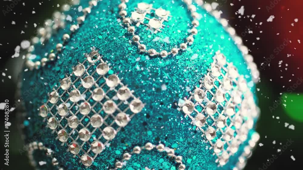 Greeting Season concept.Macro with Dolly of ornaments on a Christmas tree with decorative light and falling snow in 4k (UHD) Greeting Season concept.Macro with Dolly of ornaments on a Christmas tree with decorative light and falling snow in 4k (UHD)
