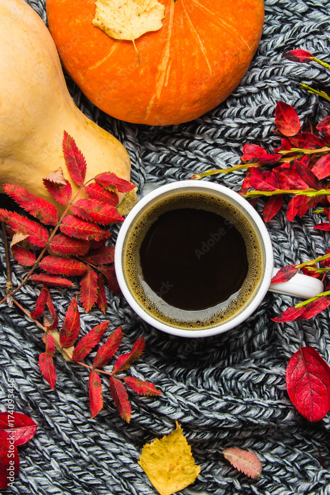 Mug of hot coffee in autumn setting on a wooden table with a knitted scarf, sweater. Comfort, warmth, cozy. Mug of hot coffee in autumn setting on a wooden table with a knitted scarf, sweater. Comfort, warmth, cozy.