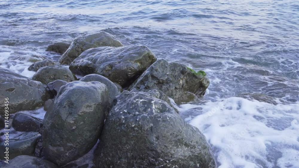 Water splashing on the rocky shore whith splash Slow motion Water splashing on the rocky shore whith splash Slow motion