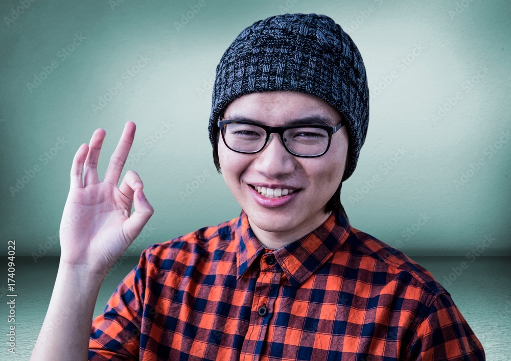 Fototapeta premium Millennial man making ok sign in green room