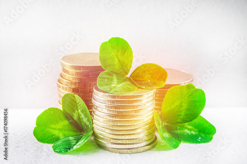 Stacks of Russian coins with clover leaves on a gray background with droplets of water. St.Patrick 's Day. photo