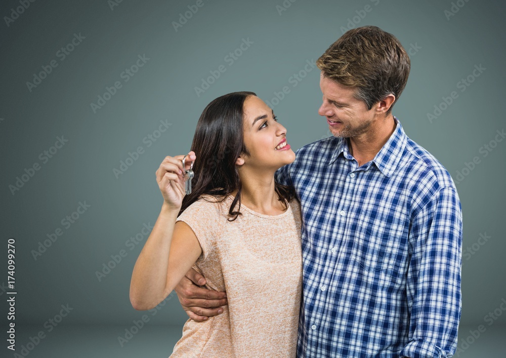 Couple Holding key in front of vignette Couple Holding key in front of vignette