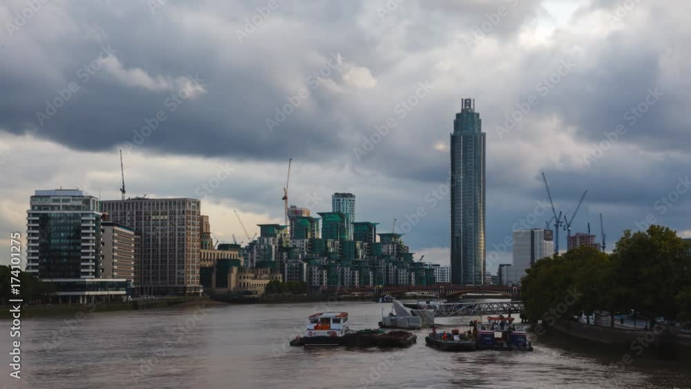 London Time-Lapse, St George Wharf Tower with blue clouds and the yellow river Thames at sunset. London Time-Lapse, St George Wharf Tower with blue clouds and the yellow river Thames at sunset.