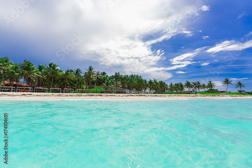 Fototapeta Naklejka Na Ścianę i Meble -  beautiful amazing tropical palm beach and tranquil turquoise ocean against blue sky background at Cuban Cayo Coco island
