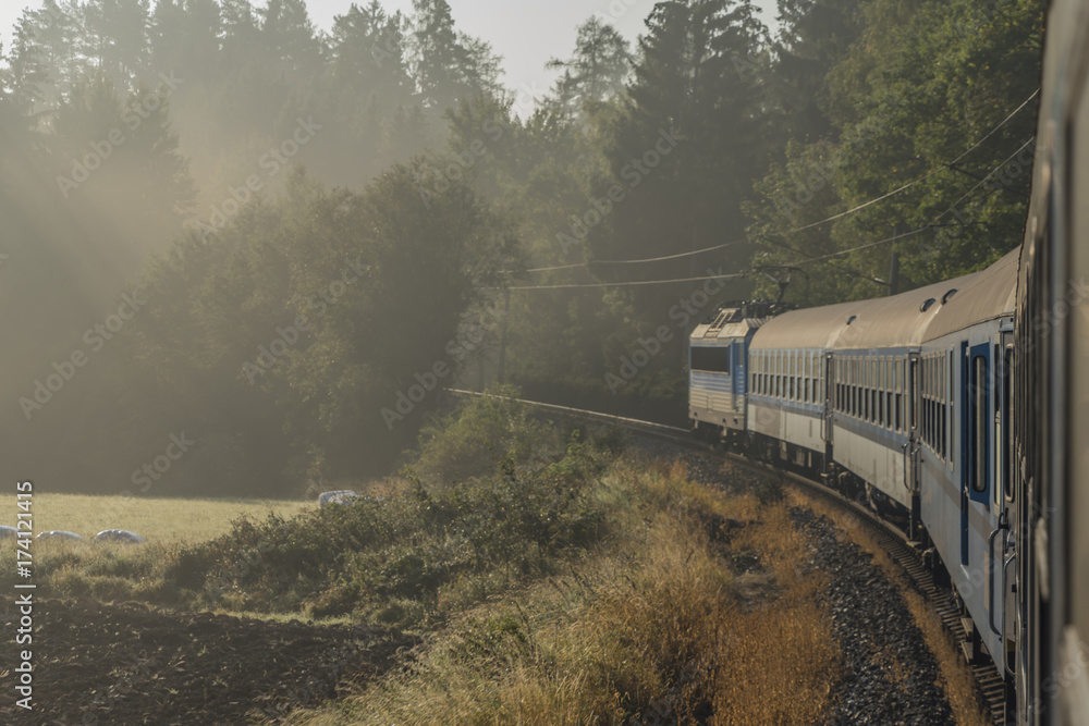 Obraz premium Fast train from Prague to south of Bohemia with sunrise