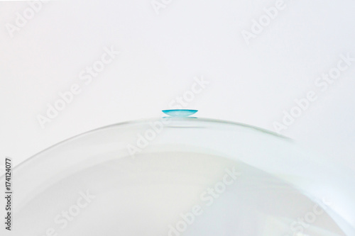 A blue lens on a glass surface.