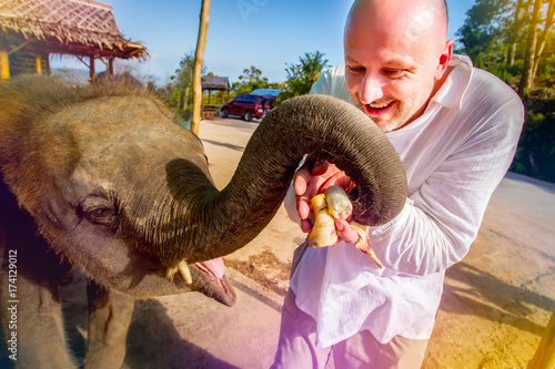 Thailand. A man is feeding ...