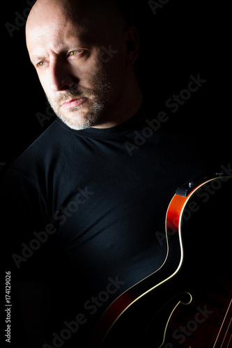 A man chooses a guitar. Aco...