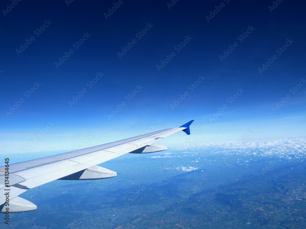 Plane wing on the sky with sunset and cloud