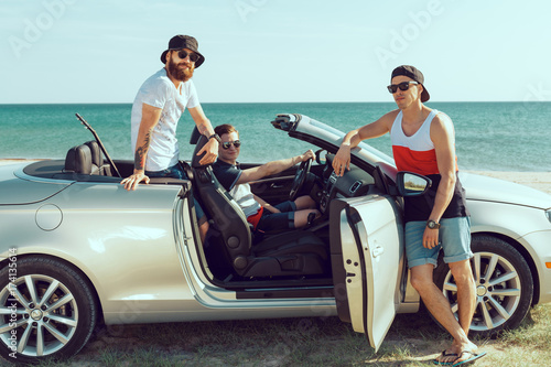 Group Of Friends Standing By Car