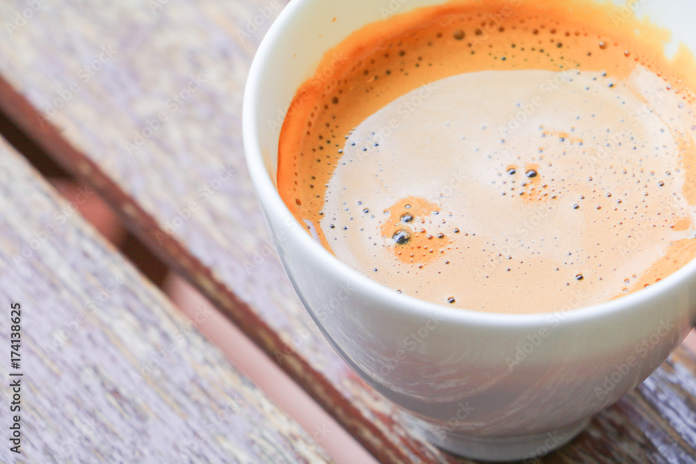 coffee espresso in white cup close up on wood background coffee espresso in white cup close up on wood background